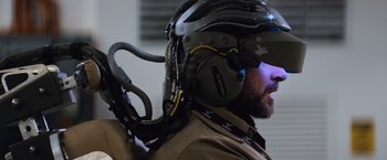 Movie still from “Chappie” (2015), directed by Neill Blomkamp – A person wearing a helmet; Close Up shot, Over the shoulder angle