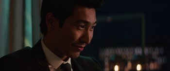 Movie still from “Charlie's Angels” (2019), directed by Elizabeth Banks – A person wearing a suit and tie; Close Up shot, Over the shoulder angle