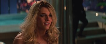 Movie still from “Charlie's Angels” (2019), directed by Elizabeth Banks – A beautiful blonde woman with long hair looking to her left; Close Up shot, Over the shoulder angle