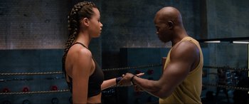 Movie still from “Charlie's Angels” (2019), directed by Elizabeth Banks – A man and a woman holding hands in a boxing ring; Medium shot, Over the shoulder angle