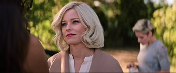 Movie still from “Charlie's Angels” (2019), directed by Elizabeth Banks – A woman with blonde hair wearing a white shirt and jacket; Close Up shot, Over the shoulder angle