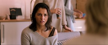 Movie still from “Charlie's Angels” (2019), directed by Elizabeth Banks – A young woman is looking at the camera while another woman is standing behind her; Close Up shot, Over the shoulder angle