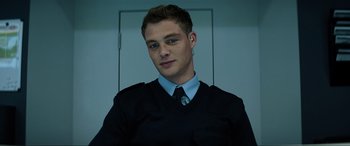 Movie still from “Charlie's Angels” (2019), directed by Elizabeth Banks – A young man in a blue shirt and a blue neck tie; Close Up shot, Low angle