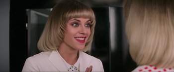 Movie still from “Charlie's Angels” (2019), directed by Elizabeth Banks – A person wearing a suit and tie; Close Up shot, Over the shoulder angle