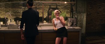 Movie still from “Charlie's Angels” (2019), directed by Elizabeth Banks – A woman is sitting at a counter and eating; Medium shot, High angle
