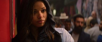 Movie still from “Charlie's Angels” (2019), directed by Elizabeth Banks – A person wearing a hooded jacket; Close Up shot, Over the shoulder angle