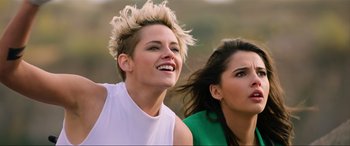 Movie still from “Charlie's Angels” (2019), directed by Elizabeth Banks – Two young women are standing together and smiling; Close Up shot, Low angle