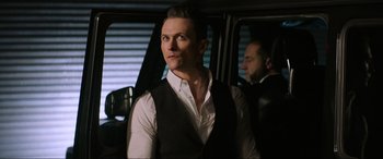 Movie still from “Charlie's Angels” (2019), directed by Elizabeth Banks – A man standing in front of a window in a car; Close Up shot, Over the shoulder angle