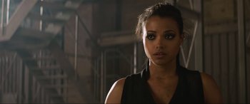 Movie still from “Charlie's Angels” (2019), directed by Elizabeth Banks – A woman in a black shirt is looking at the camera; Close Up shot, Over the shoulder angle