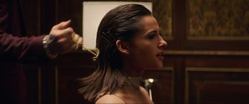 Movie still from “Charlie's Angels” (2019), directed by Elizabeth Banks – A woman with long brown hair is getting her hair done; Close Up shot, Over the shoulder angle