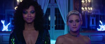 Movie still from “Charlie's Angels” (2019), directed by Elizabeth Banks – Two beautiful women standing next to each other in front of a window; Medium shot, Low angle