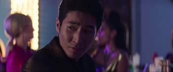 Movie still from “Charlie's Angels” (2019), directed by Elizabeth Banks – A person wearing a black shirt; Close Up shot, Over the shoulder angle