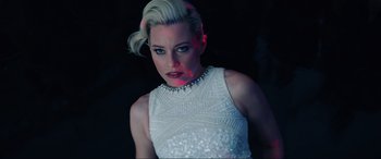 Movie still from “Charlie's Angels” (2019), directed by Elizabeth Banks – A woman in a white dress is posing for the camera; Close Up shot, Low angle