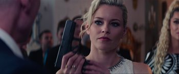 Movie still from “Charlie's Angels” (2019), directed by Elizabeth Banks – A beautiful blonde woman holding a gun in her hand; Close Up shot, Over the shoulder angle