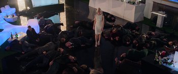 Movie still from “Charlie's Angels” (2019), directed by Elizabeth Banks – A group of people laying on the floor and a woman standing in the middle of the floor; Wide shot, High angle