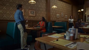 Movie still from “Cheaper by the Dozen” (2022), directed by Gail Lerner – A man and a woman are sitting in a restaurant; Wide shot, Over the shoulder angle