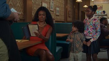 Movie still from “Cheaper by the Dozen” (2022), directed by Gail Lerner – A woman sitting at a table with a child; Medium shot, Over the shoulder angle