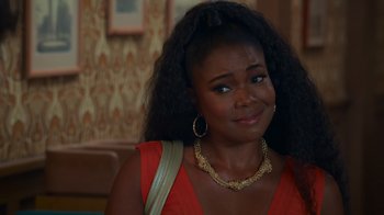 Movie still from “Cheaper by the Dozen” (2022), directed by Gail Lerner – A woman in a red dress and gold necklace; Close Up shot, Over the shoulder angle