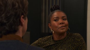 Movie still from “Cheaper by the Dozen” (2022), directed by Gail Lerner – A woman sitting in front of a man in front of a mirror; Close Up shot, Over the shoulder angle