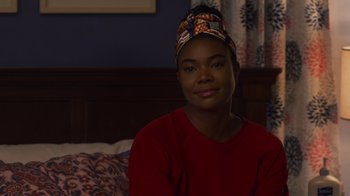 Movie still from “Cheaper by the Dozen” (2022), directed by Gail Lerner – A woman sitting on top of a bed in a room; Close Up shot, Over the shoulder angle