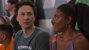 Movie still from “Cheaper by the Dozen” (2022), directed by Gail Lerner – A man and a woman sitting next to each other; Close Up shot, Over the shoulder angle