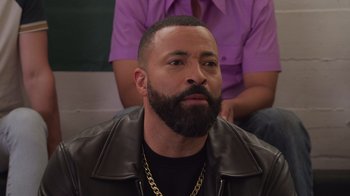 Movie still from “Cheaper by the Dozen” (2022), directed by Gail Lerner – A man with a goatee and a leather jacket; Close Up shot, Over the shoulder angle