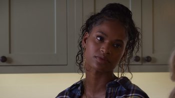 Movie still from “Cheaper by the Dozen” (2022), directed by Gail Lerner – A young woman wearing a checkered button up shirt; Close Up shot, Over the shoulder angle