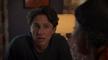 Movie still from “Cheaper by the Dozen” (2022), directed by Gail Lerner – A man sitting in front of another man in front of a lamp; Close Up shot, Over the shoulder angle