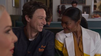 Movie still from “Cheaper by the Dozen” (2022), directed by Gail Lerner – A man and a woman sitting next to each other; Medium shot, Over the shoulder angle