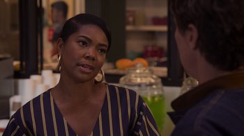 Movie still from “Cheaper by the Dozen” (2022), directed by Gail Lerner – A woman talking to a man in a kitchen; Close Up shot, Over the shoulder angle