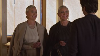 Movie still from “Cheaper by the Dozen” (2022), directed by Gail Lerner – A couple of women standing next to each other in a room; Medium shot, Over the shoulder angle