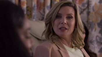 Movie still from “Cheaper by the Dozen” (2022), directed by Gail Lerner – A person sitting on a couch; Close Up shot, Over the shoulder angle