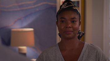 Movie still from “Cheaper by the Dozen” (2022), directed by Gail Lerner – A person wearing a head scarf; Close Up shot, Over the shoulder angle