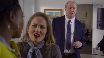 Movie still from “Cheaper by the Dozen” (2022), directed by Gail Lerner – A man and a woman are standing in a living room; Medium shot, Over the shoulder angle