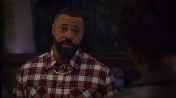 Movie still from “Cheaper by the Dozen” (2022), directed by Gail Lerner – A man with a beard wearing a red and white plaid shirt; Medium shot, Over the shoulder angle