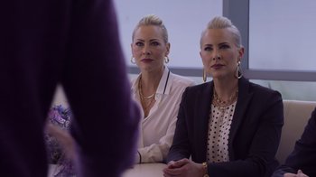 Movie still from “Cheaper by the Dozen” (2022), directed by Gail Lerner – A couple of women sitting next to each other at a table; Medium shot, Over the shoulder angle