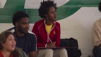 Movie still from “Cheaper by the Dozen” (2022), directed by Gail Lerner – A woman sitting next to a man holding a clipboard; Medium shot, Over the shoulder angle