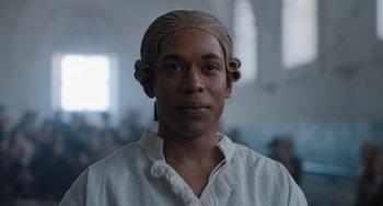 A man in a white shirt with blonde hair