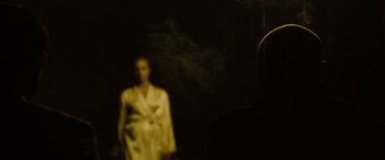 Movie still from “Enemy” (2013), directed by Denis Villeneuve – A blurry image of a person in a robe; Medium shot, Over the shoulder angle