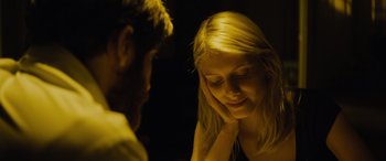 Movie still from “Enemy” (2013), directed by Denis Villeneuve – A man and a woman sitting next to each other in a dark room; Close Up shot, Over the shoulder angle
