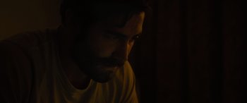 Movie still from “Enemy” (2013), directed by Denis Villeneuve – A person with a beard; Close Up shot, Over the shoulder angle