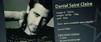 Movie still from “Enemy” (2013), directed by Denis Villeneuve – A man's face with a description of his height and weight; Extreme Close Up shot, High angle