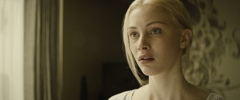 Movie still from “Enemy” (2013), directed by Denis Villeneuve – A person looking at the camera; Close Up shot, Over the shoulder angle
