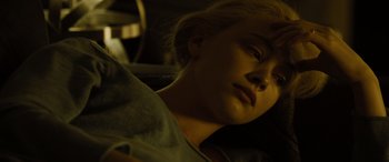 Movie still from “Enemy” (2013), directed by Denis Villeneuve – A woman with blonde hair laying in the dark; Close Up shot, High angle