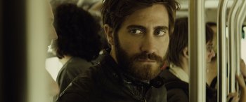Movie still from “Enemy” (2013), directed by Denis Villeneuve – A person with a beard; Close Up shot, Over the shoulder angle