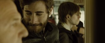 Movie still from “Enemy” (2013), directed by Denis Villeneuve – A man and a woman are sitting in a room together; Close Up shot, Over the shoulder angle