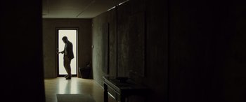Movie still from “Enemy” (2013), directed by Denis Villeneuve – A hallway with a table and a mirror; Wide shot, Low angle