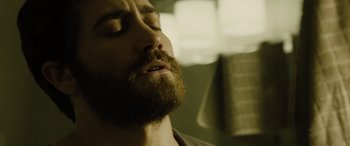 Movie still from “Enemy” (2013), directed by Denis Villeneuve – A person with his eyes closed; Close Up shot, Low angle
