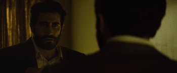 Movie still from “Enemy” (2013), directed by Denis Villeneuve – A man looking at himself in the mirror; Close Up shot, Over the shoulder angle