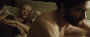 Movie still from “Enemy” (2013), directed by Denis Villeneuve – A man and a woman in a bed with a man looking at them; Close Up shot, Over the shoulder angle